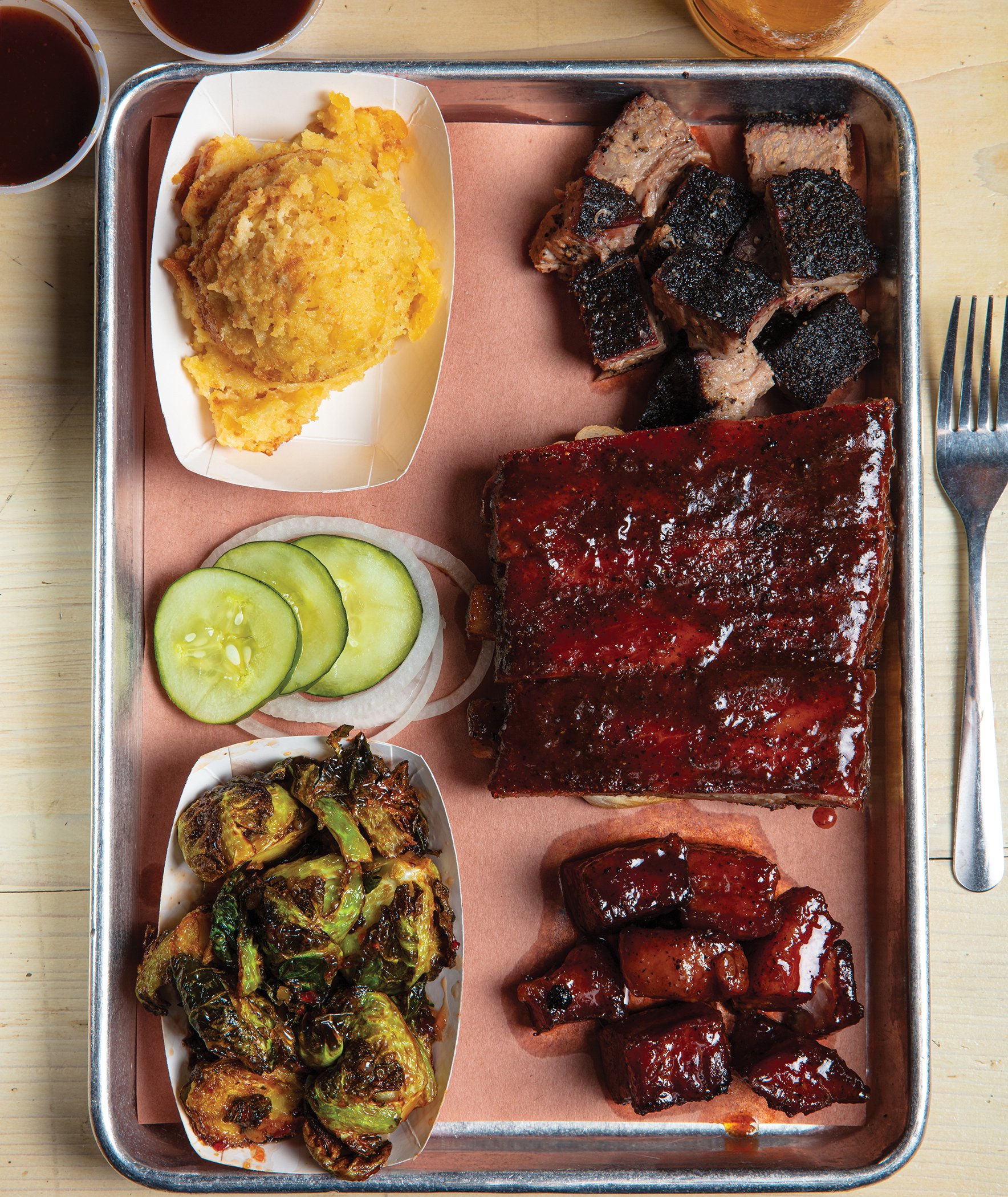 A succulent plate of beef ribs from Central City BBQ, showcasing the rich, smoky flavors and tender meat characteristic of New Orleans barbecue.