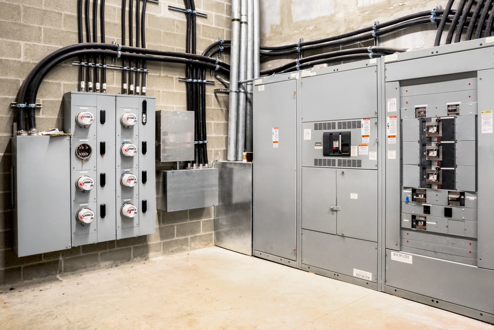 Electrical room of residential or business building. Multiple smart meters, main power breaker, meter stacks and cabinets. Electrician in New Orleans