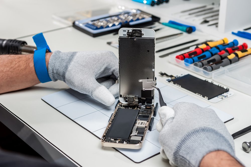 Close-up images depicting the intricate process of smartphone repair by skilled technicians in an electronics repair store
