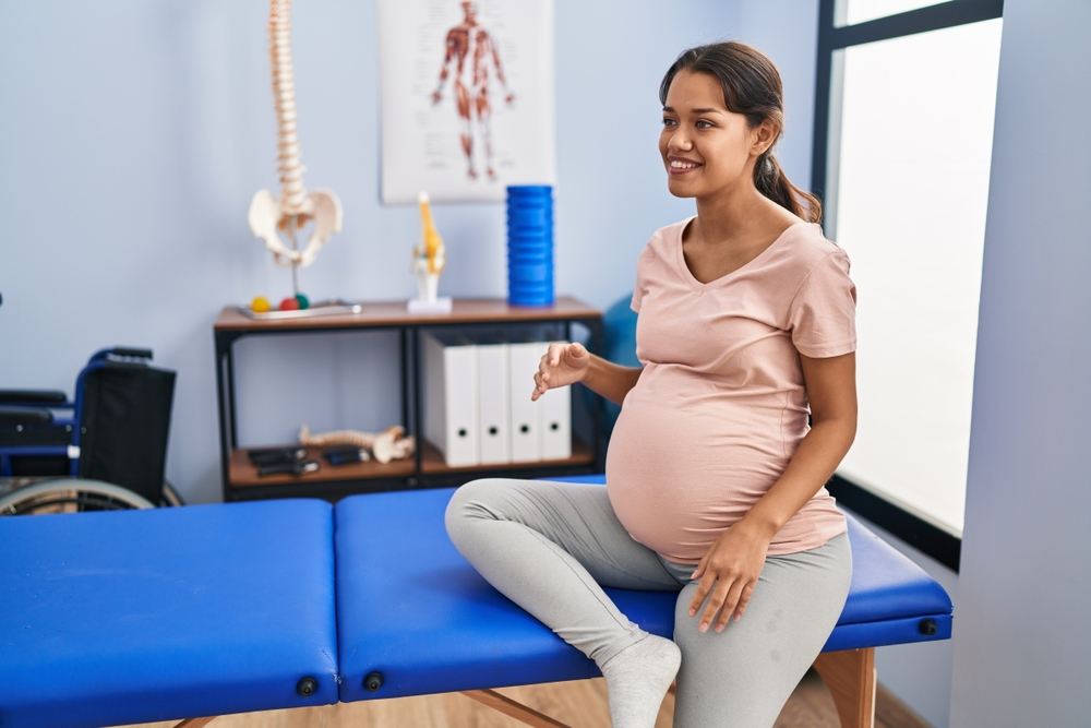 Expectant mother receiving prenatal chiropractic consultation at a clinic. New Orleans chiropractor.