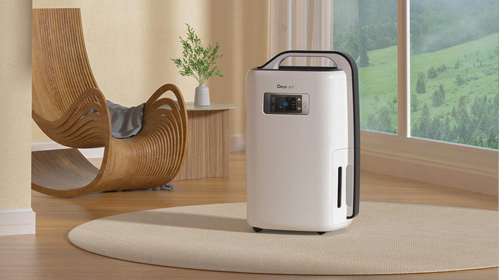 A portable dehumidifier in a sunny living room next to a modern wooden chair, with a view of rolling hills outside the window.